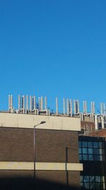 Buildings against clear blue sky