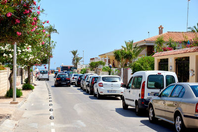 Cars on road against clear blue sky