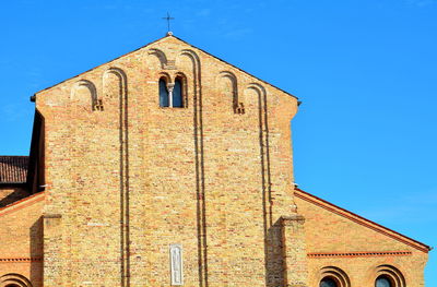 Low angle view of building against clear blue sky