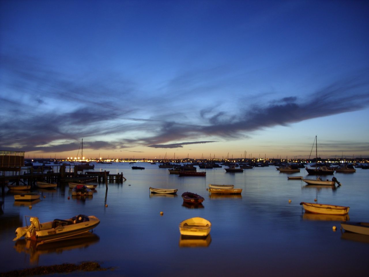 water, nautical vessel, moored, transportation, boat, mode of transport, sky, waterfront, harbor, sea, reflection, cloud - sky, tranquil scene, tranquility, dusk, pier, scenics, lake, beauty in nature, sunset