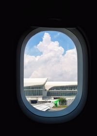 View of cloudy sky seen through airplane window