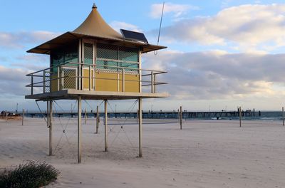 Lifeguard hut on beach against sky