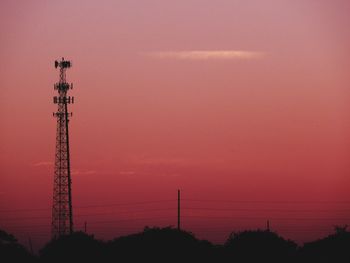 Silhouette of electricity pylon against sky during sunset