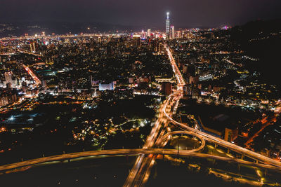 High angle view of illuminated city buildings at night