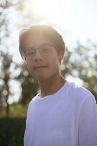 Portrait of young man while standing at park