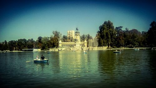 Scenic view of lake against clear blue sky