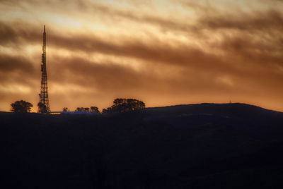 Silhouette landscape against sky during sunset