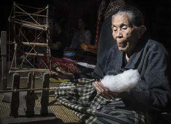 Portrait of woman sitting in traditional clothing looking away