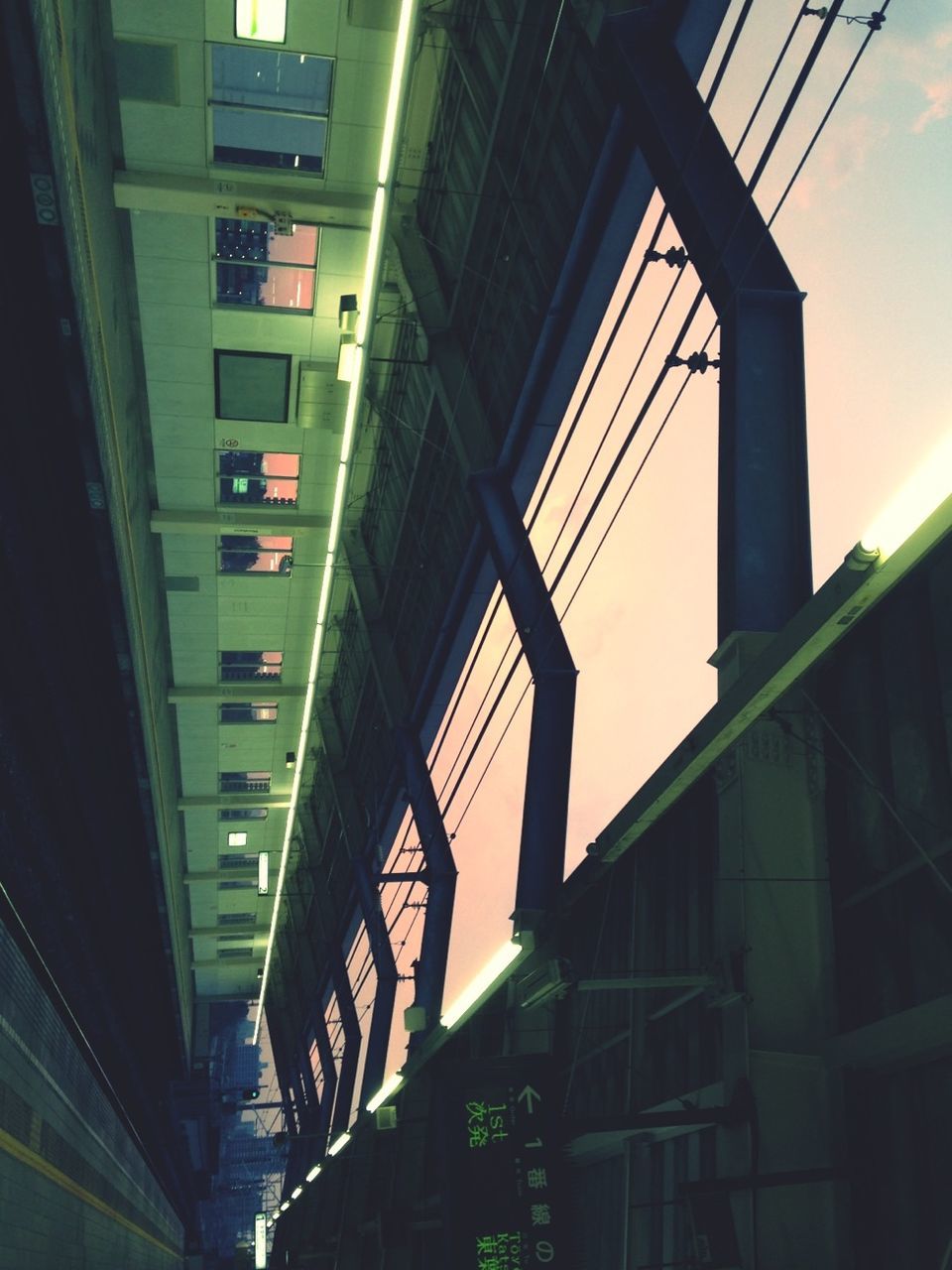 architecture, built structure, illuminated, transportation, building exterior, public transportation, rail transportation, railroad track, city, low angle view, connection, railroad station, bridge - man made structure, building, no people, night, diminishing perspective, railroad station platform, sky, outdoors