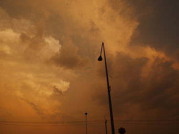 Low angle view of silhouette pole against sky during sunset