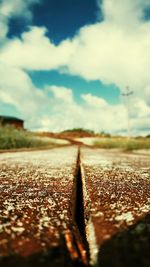 Surface level of railroad track against sky