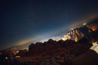 Scenic view of mountains against sky at night