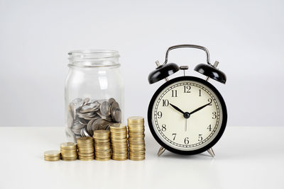 Close-up of coins on table against white background