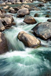 Stream flowing through rocks in sea