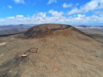 Scenic view of arid landscape against sky volcano crater aeriel view