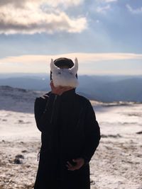 Man standing by sea against sky