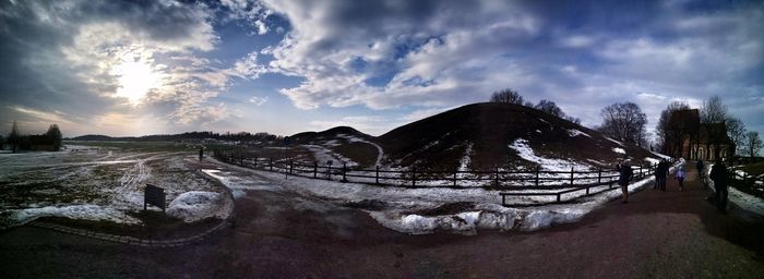 Panoramic view of frozen lake against sky during winter