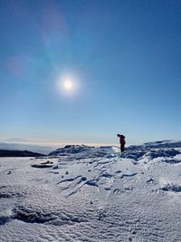 Rear view of man walking on snow