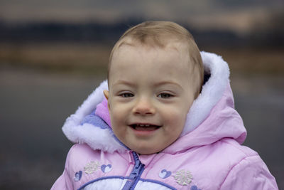 Portrait baby girl wearing warm clothing standing outdoors