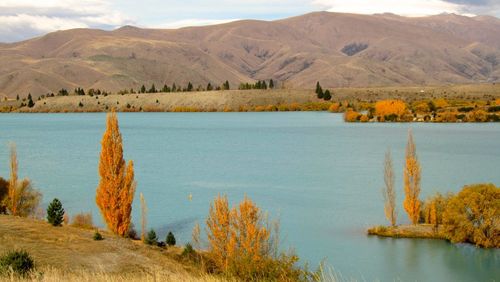 Scenic view of lake and mountains against sky