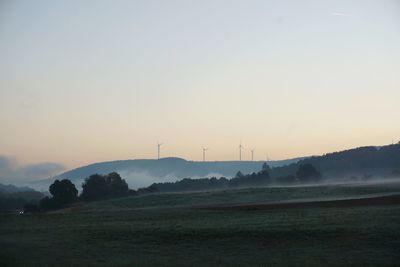 Scenic view of field against sky during sunset