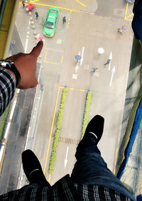 Low section of man standing on tiled floor