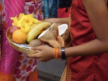 Midsection of man holding fruits