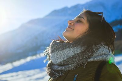 Side view of woman looking away against mountain