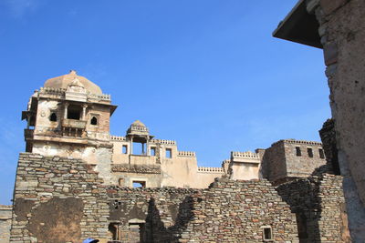 Low angle view of historic building against blue sky