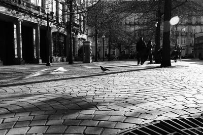 Man walking on footpath in city