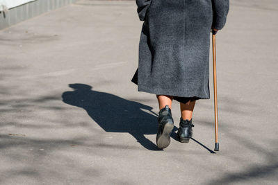 Low section of people walking on street