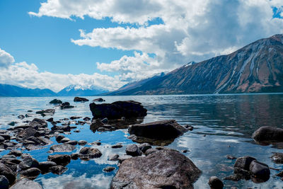 Scenic view of sea and mountains against sky