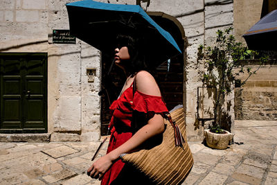 Side view of young woman in basket