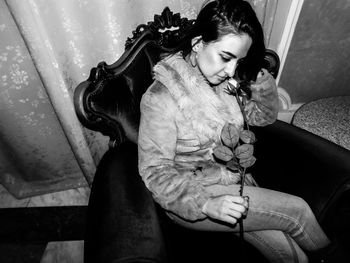 Young woman sitting outdoors