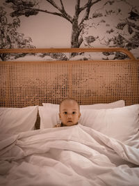 Young boy sleeping on bed at home