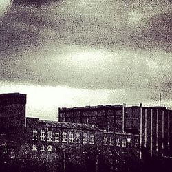 Buildings against cloudy sky