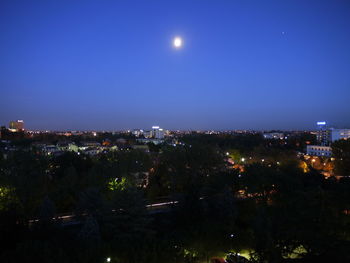 High angle view of illuminated buildings against sky at night