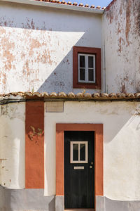 Old white two-story house in europe on a sunny day