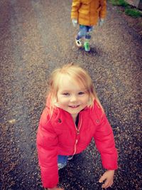 Portrait of a smiling girl standing on road