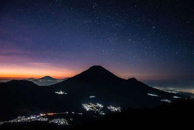 Scenic view of illuminated mountains against sky at night