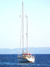 Sailboat sailing on sea against sky