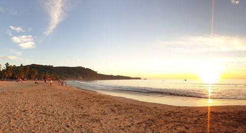 Scenic view of beach against sky during sunset