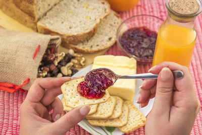 Close-up of woman with jam and crackers