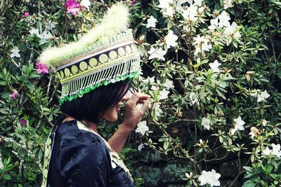 Portrait of woman holding plants