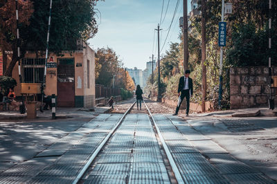 People walking on footpath in city