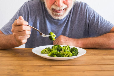 Midsection of man eating food