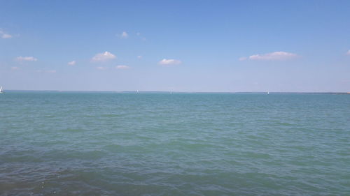 Scenic view of sea against blue sky