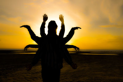 Silhouette people at beach during sunset