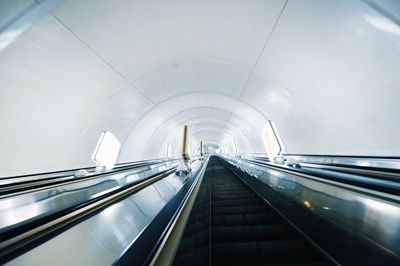 Low angle view of escalator in tunnel