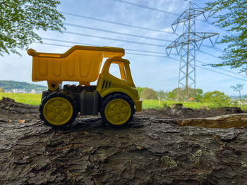 Toy truck on a log in the forest against a soft background